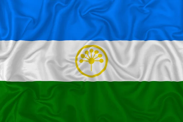波状の絹織物の背景にバシコルトスタン共和国の旗 — ストック写真