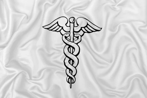 Caduceus Símbolo Médico Uma Textura Tecido Cetim Seda Branca — Fotografia de Stock