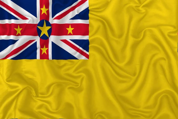 Флаг Ниуэ Волнистом Шелковом Текстильном Фоне — стоковое фото