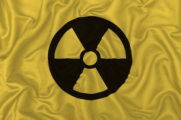 Zicht Van Het Nucleaire Symbool Gele Zijde Satijnen Stof Textuur — Stockfoto