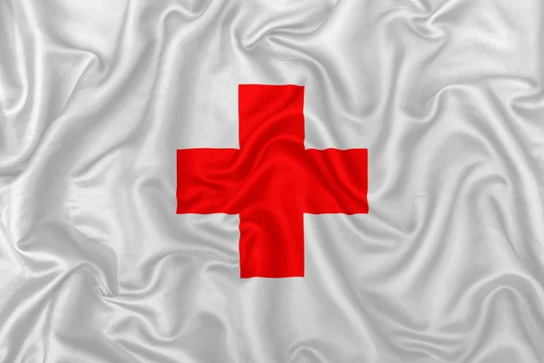 Red Medical Kruis Een Golvende Zijde Satijnen Stof Textuur Achtergrond — Stockfoto