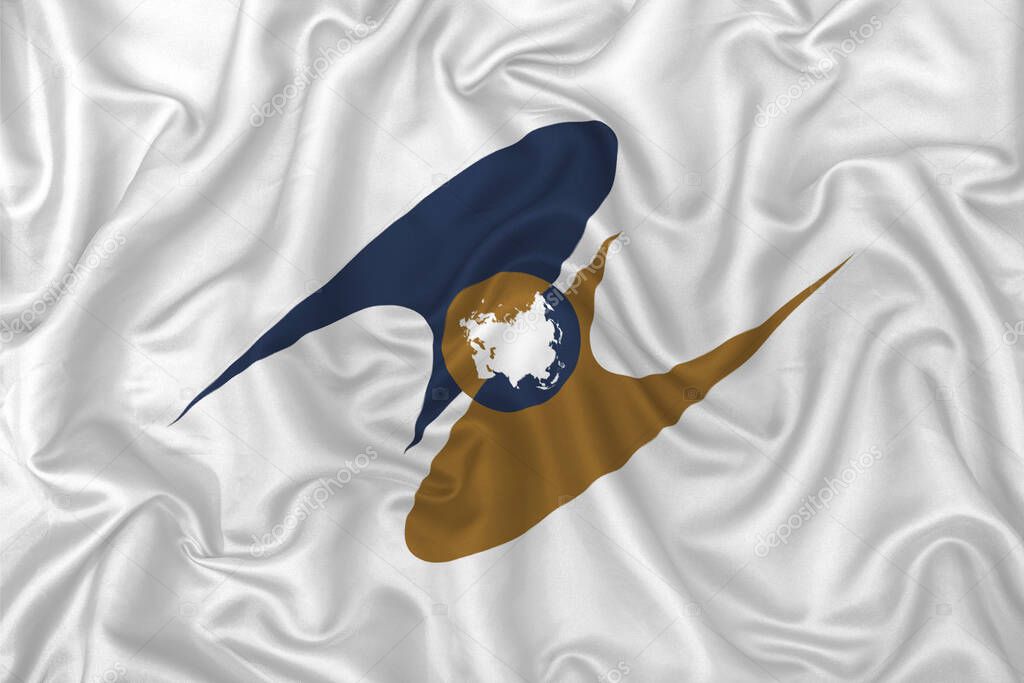 Eurasian Economic Union flag on wavy silk textile fabric background.