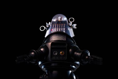 Siyah arka planda izole edilmiş eski model bir robot oyuncak..