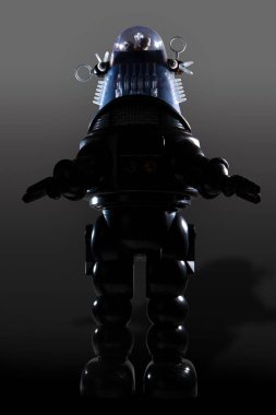 Gri arka planda izole edilmiş eski model bir robot oyuncak..