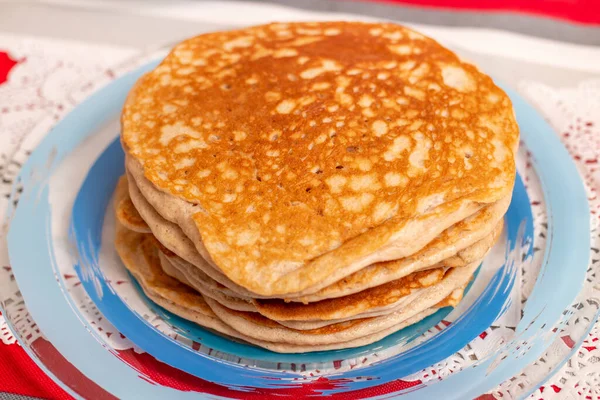 simple american style fluffy pancakes stacked on a pile.