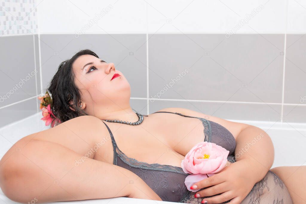woman wearing sensual lingerie on a milky bathtub.