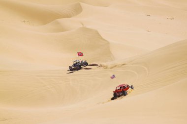 ATV riders in the vast desert clipart