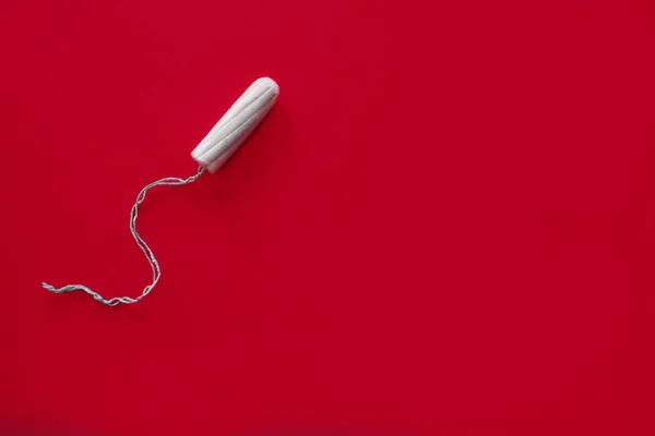 Medical female swab on a red background, top view — Stock Fotó
