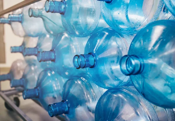 background of plastic bottles, preparation for washing and processing plastic, a water production plant, drinking purified water, many plastic bottles are stacked in a row
