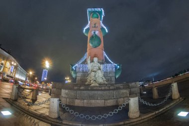 Geceleri St. Petersburg 'daki Rostral sütununun alışılmadık manzarası. Vasilievsky Adası 'nın tükürüğüyle ilgili Noel sütunlarında Rostral sütun