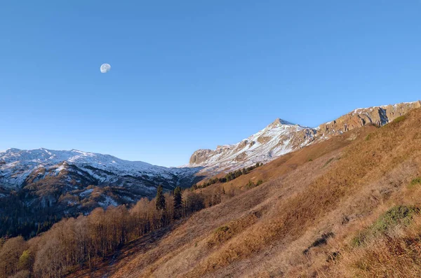 Dawn and moon in the Caucasus Mountains.