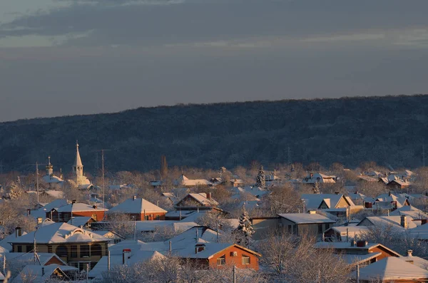 Orthodox Church among the single-storey houses. Winter evening. Stock Picture