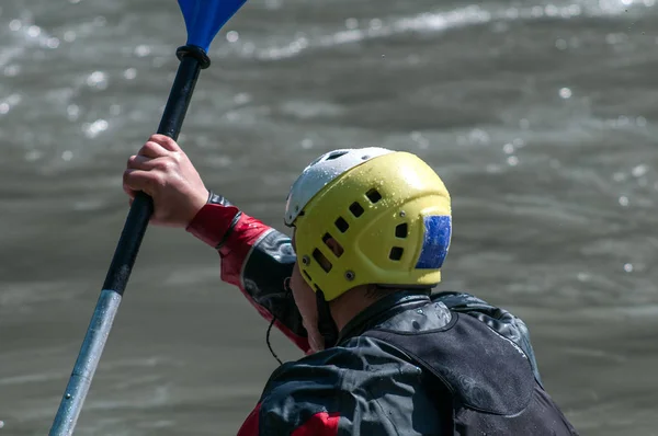 Kayakers. Rear view on the shoulders. The helmet.