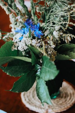 Tahta masadaki kır çiçekleri. Mavi ve beyaz çiçekler.