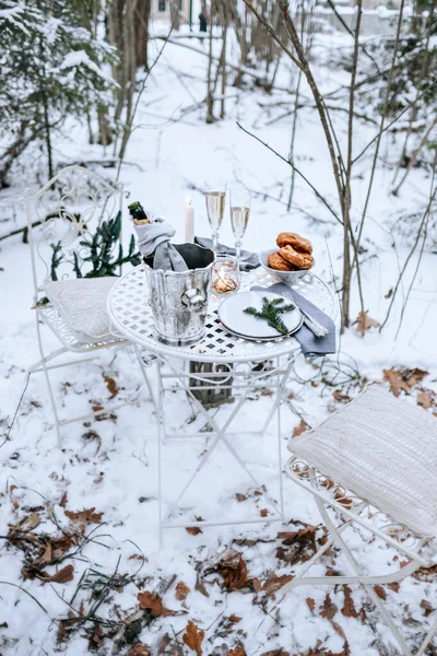 Romantic dinner in the winter forest.