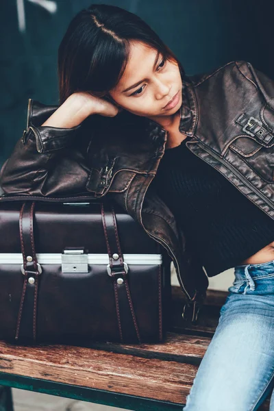 Gorgeous girl posing with leather bag, hipster style