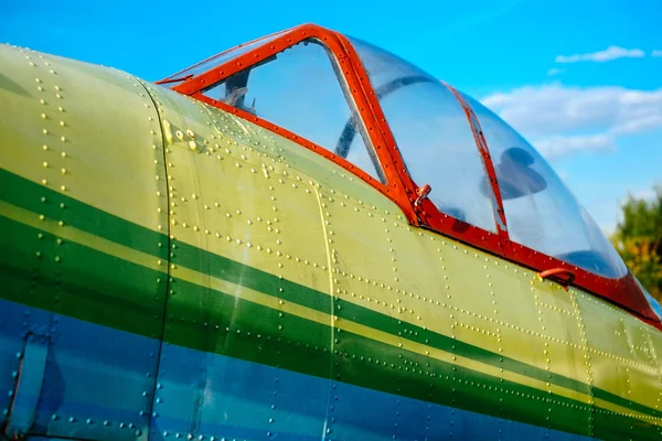 Cockpit detail of colorful airplane on the grass of the airfield — Stock Photo, Image