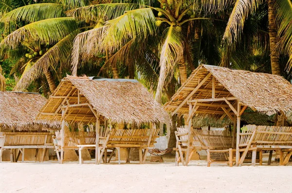 Sombras de verão e poltrona de bambu na praia tropical de areia branca — Fotografia de Stock