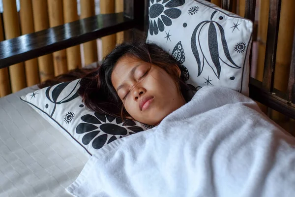 Young Asian woman sleeping peacefully in the bacony during summer vacation