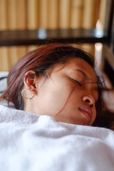 Young Asian woman sleeping peacefully in the bacony during summer vacation