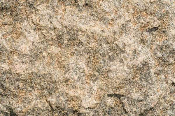 Texture of the surface of an antique stone wall under natural light by sunlight, abstract background — Stock Photo, Image