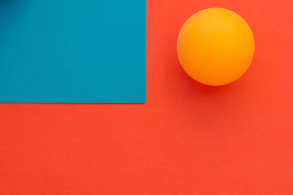 Yellow tennis ball on a red blue background — Stock Photo, Image