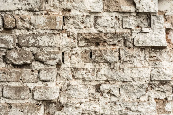 Textura de una antigua pared de ladrillo en ruinas de un edificio antiguo — Foto de Stock