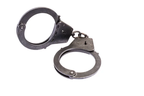 Black metal handcuffs with small scratches on white background — Stock Photo, Image