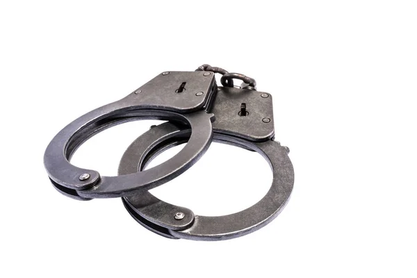 Black metal handcuffs with small scratches on white background — Stock Photo, Image