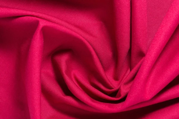 Textur aus rotem Baumwollstoff mit willkürlichen Biegungen und Wellen, abstrakter Hintergrund — Stockfoto