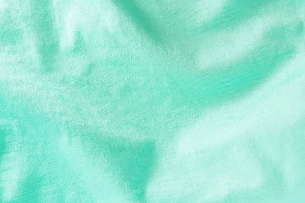 Textur einer grünen Baumwollfaseroberfläche, die einen abstrakten Hintergrund bildet — Stockfoto