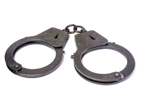 Black metal handcuffs with small scratches on white background — Stock Photo, Image