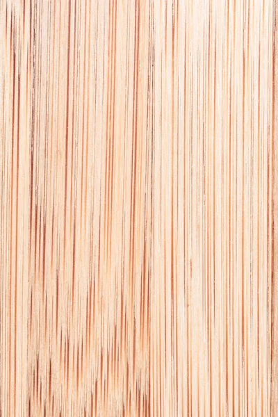 texture of smooth wood with vertical arrangement of pattern, abstract close-up background