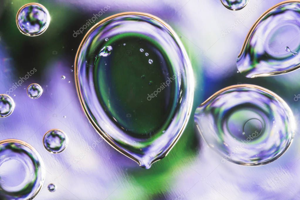 drops of water on the surface of the oil, variation of dissimilar liquids, macro abstract background
