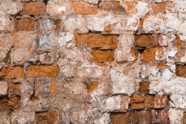 Textura de una antigua pared de un edificio antiguo con una capa de yeso en ruinas y ladrillos rojos agrietados, fondo abstracto — Foto de Stock