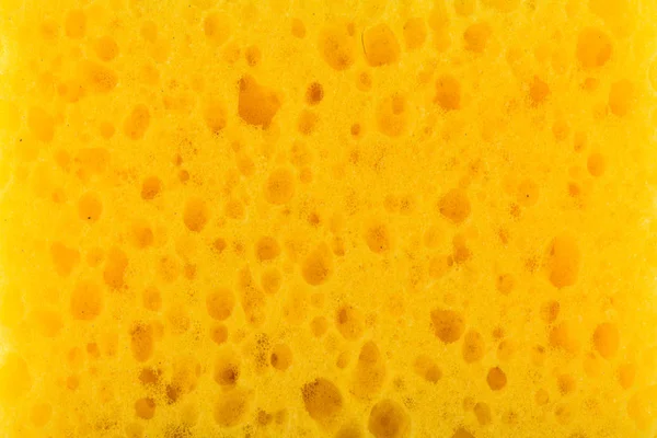テクスチャ黄色発泡ゴム、合成スポンジ、クローズ アップの背景の大きな細孔を — ストック写真