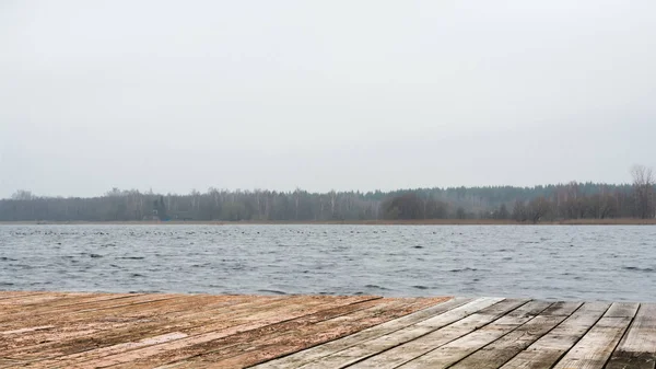 Wooden board lake with autumn forest and lake