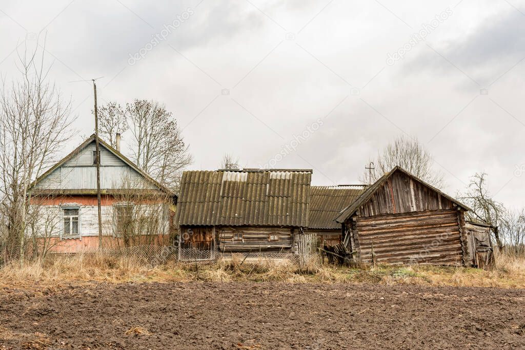 Old village abandoned wooden house And a woodshed, a woodcutter
