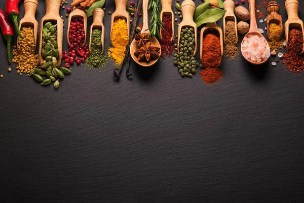 Various spices on black slate. Top view with free space — Stock Photo, Image