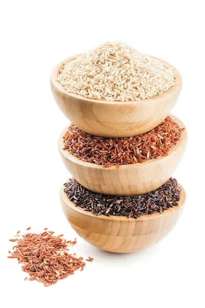 Different types of rice in a wooden bowls isolated on white — Stock Photo, Image