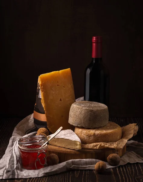 Formaggio, marmellata e vino sul legno grezzo — Foto Stock