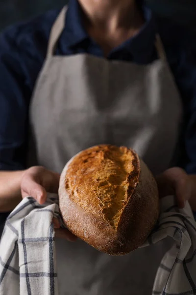 Baker holding fresh homemade bread — Stok Foto