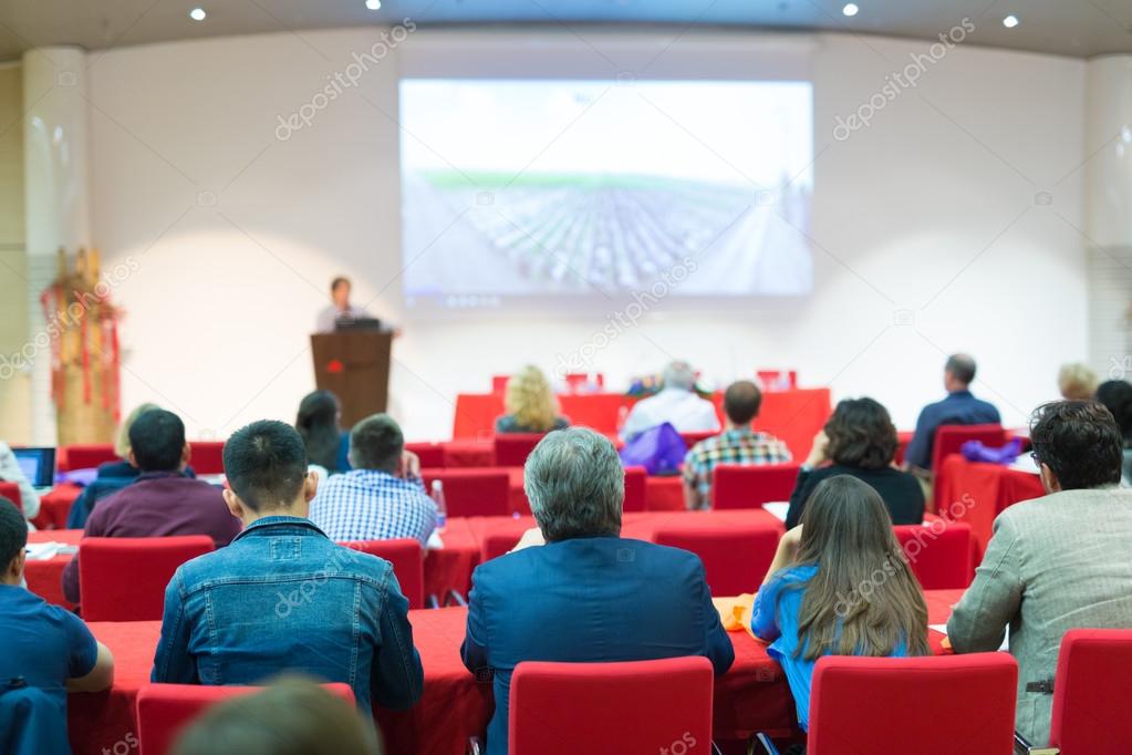 Audience in lecture hall on scientific conference.