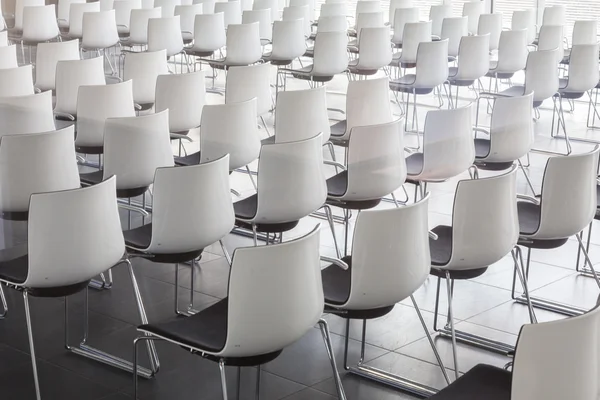 Empty white chairs in contemporary conference hall with — Stock Photo, Image