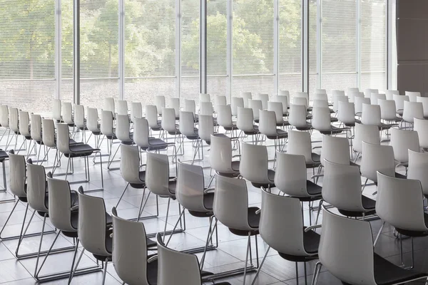 Empty white chairs in contemporary conference hall with — Stock Photo, Image