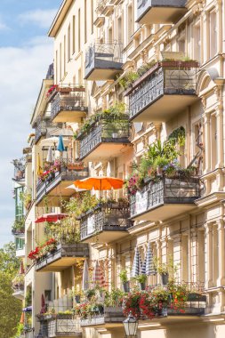 Traditional European Balcony with colorful flowers and flowerpots. clipart