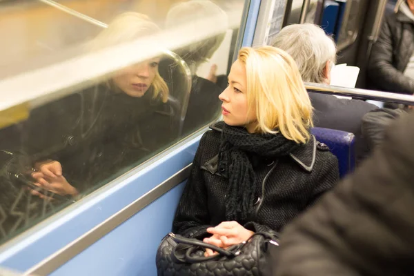 Woman looking out metros window. — Stock Photo, Image
