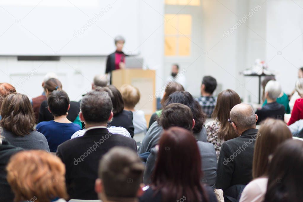 Woman giving presentation on business conference.