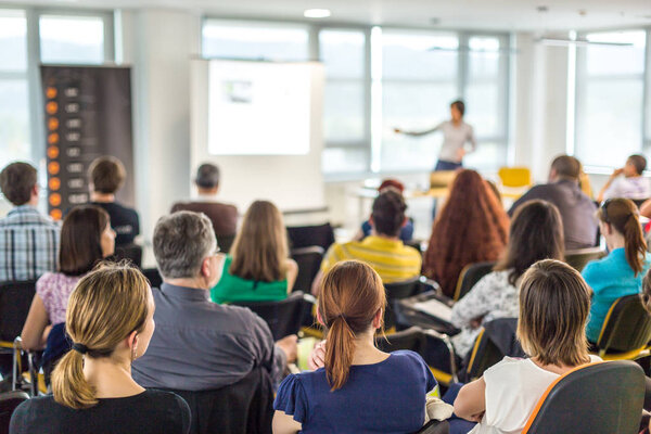 Woman giving presentation on business conference.