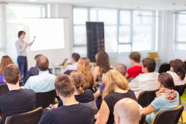 Woman giving presentation on business conference.
